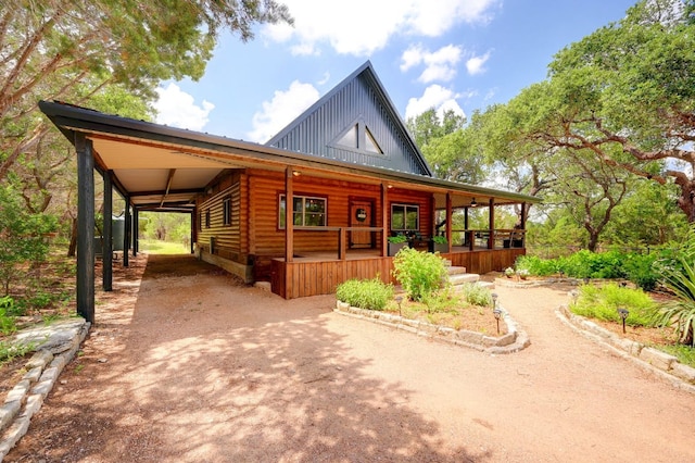 4255 Fm 3405, Georgetown, TX 78633 - view of front of house with board and batten siding, a porch, faux log siding, driveway, and an attached carport