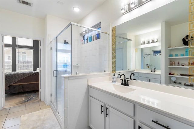 241 Oleander Loop, Buda, TX 78610 - bathroom featuring ensuite bathroom, vanity, a shower stall, and tile patterned flooring