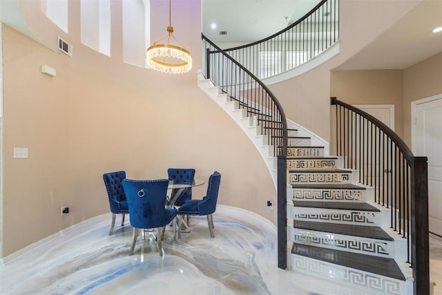 241 Oleander Loop, Buda, TX 78610 - stairway featuring a towering ceiling and baseboards