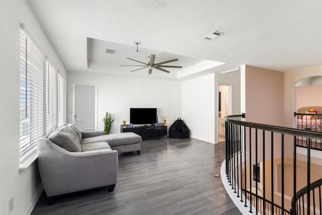 241 Oleander Loop, Buda, TX 78610 - living room with a tray ceiling, wood finished floors, a ceiling fan, and baseboards