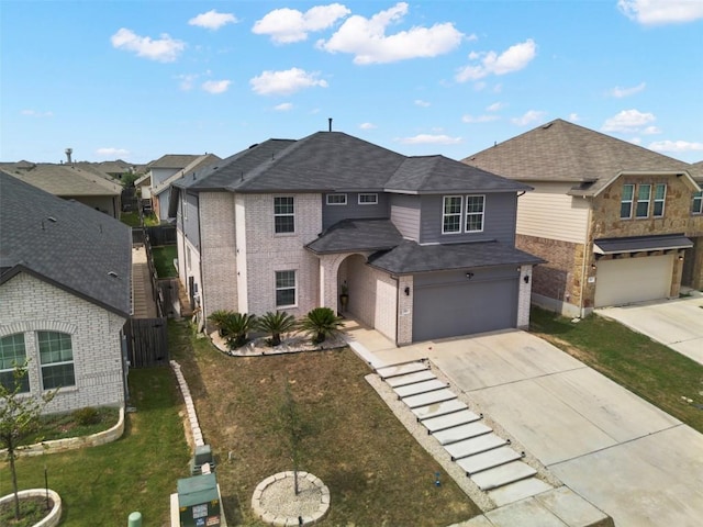 241 Oleander Loop, Buda, TX 78610 - view of front of home featuring driveway, a garage, brick siding, roof with shingles, and a residential view