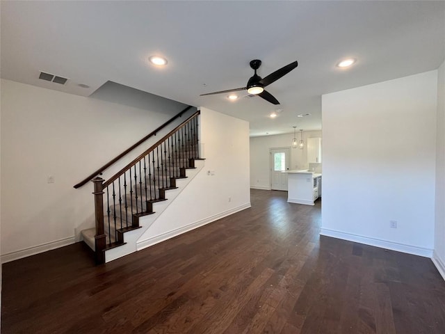2105 Tiger Trl Unit 101, Round Rock, TX 78665 - unfurnished living room with stairway, dark wood-type flooring, a ceiling fan, baseboards, and recessed lighting