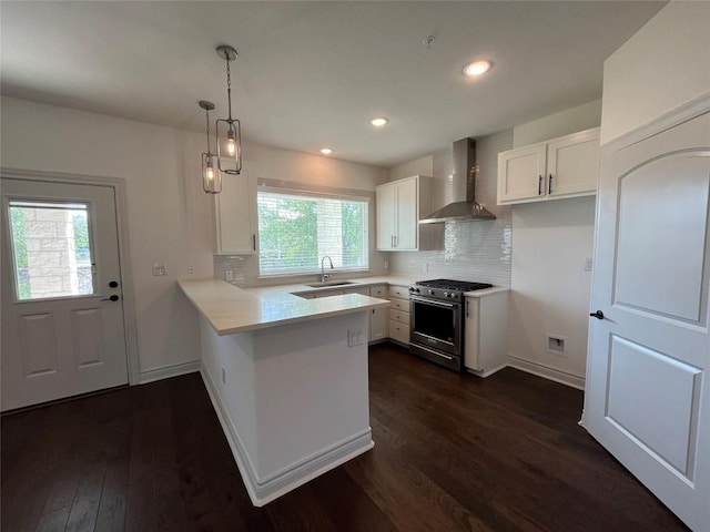 2105 Tiger Trl Unit 101, Round Rock, TX 78665 - kitchen with wall chimney exhaust hood, high end stainless steel range, a sink, a peninsula, and dark wood finished floors
