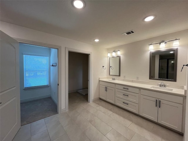 2105 Tiger Trl Unit 101, Round Rock, TX 78665 - full bath featuring double vanity, recessed lighting, tile patterned flooring, and baseboards