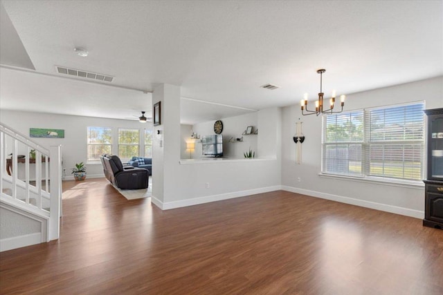 100 N Prairie Ln, Georgetown, TX 78633 - unfurnished living room with wood finished floors, stairway, a chandelier, and a ceiling fan