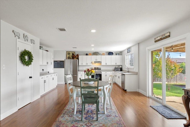 100 N Prairie Ln, Georgetown, TX 78633 - dining space with wood finished floors, baseboards, and recessed lighting