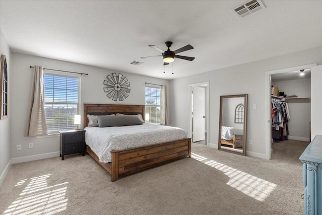 100 N Prairie Ln, Georgetown, TX 78633 - bedroom featuring light carpet, a walk in closet, and ceiling fan