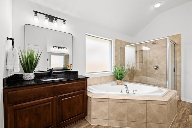 270 Harris Dr, Austin, TX 78737 - full bath featuring a bath, vanity, lofted ceiling, tiled shower, and wood finished floors