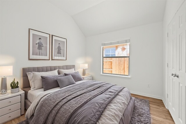 270 Harris Dr, Austin, TX 78737 - bedroom with lofted ceiling, a closet, light wood-type flooring, and baseboards