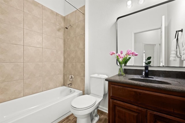 270 Harris Dr, Austin, TX 78737 - bathroom featuring vanity, toilet, wood finished floors, and tub / shower combination