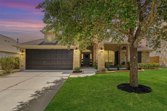 270 Harris Dr, Austin, TX 78737 - view of front facade with concrete driveway, stone siding, a yard, and a garage