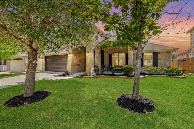 270 Harris Dr, Austin, TX 78737 - view of property hidden behind natural elements featuring stone siding, concrete driveway, and a garage