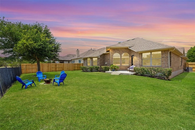 270 Harris Dr, Austin, TX 78737 - yard at dusk featuring an outdoor fire pit, a patio area, and central AC unit