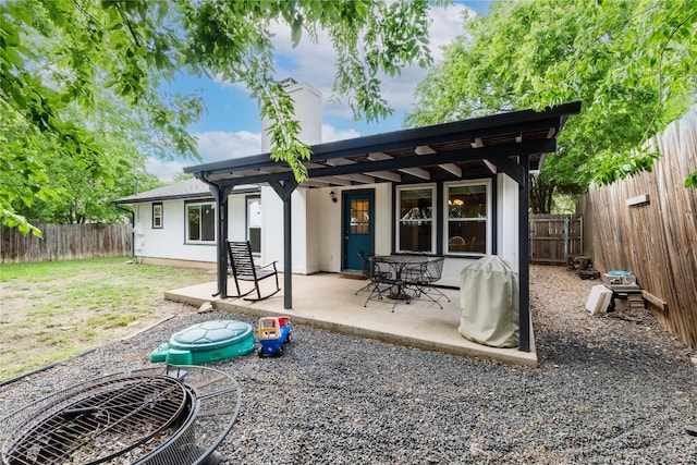 1404 Troy Ln, Round Rock, TX 78664 - rear view of house with a fenced backyard, a patio area, and a chimney