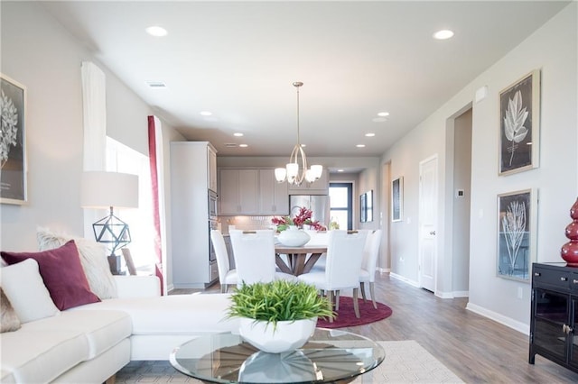 813 Vaughn St, Georgetown, TX 78628 - living room with a chandelier, light wood-style floors, recessed lighting, and baseboards