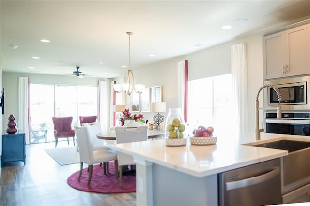 813 Vaughn St, Georgetown, TX 78628 - kitchen featuring stainless steel appliances, light countertops, recessed lighting, open floor plan, and decorative light fixtures