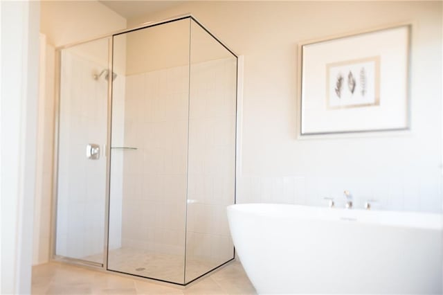 813 Vaughn St, Georgetown, TX 78628 - bathroom with a freestanding bath, a shower stall, and wainscoting
