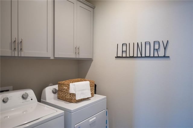 813 Vaughn St, Georgetown, TX 78628 - laundry area with washer and dryer and cabinet space
