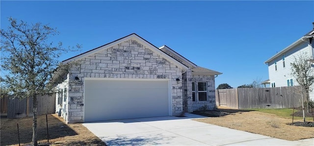 813 Vaughn St, Georgetown, TX 78628 - view of front of home with stone siding, driveway, and a garage