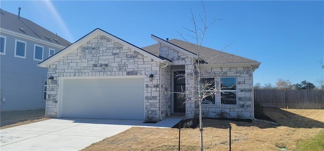 813 Vaughn St, Georgetown, TX 78628 - view of front facade featuring stone siding, an attached garage, and driveway