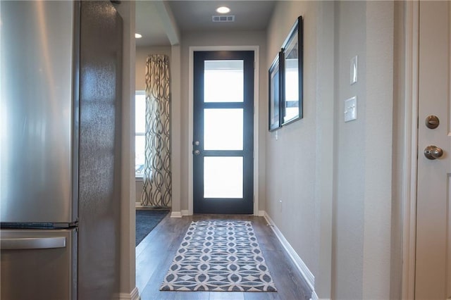 813 Vaughn St, Georgetown, TX 78628 - doorway featuring wood finished floors, plenty of natural light, and baseboards