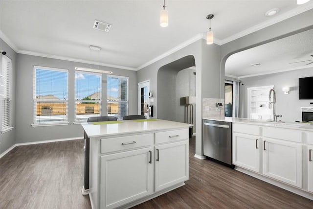 1312 Backcountry Dr, Leander, TX 78641 - kitchen featuring dishwasher, a sink, dark wood-style flooring, crown molding, and arched walkways