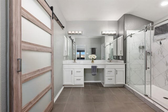 1312 Backcountry Dr, Leander, TX 78641 - full bathroom featuring tile patterned flooring, double vanity, a marble finish shower, and baseboards
