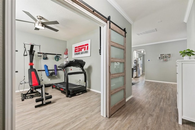 1312 Backcountry Dr, Leander, TX 78641 - workout area featuring wood finished floors, ceiling fan, arched walkways, ornamental molding, and baseboards