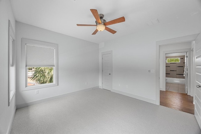 1402 E 11th St, Austin, TX 78702 - unfurnished bedroom with baseboards and multiple windows