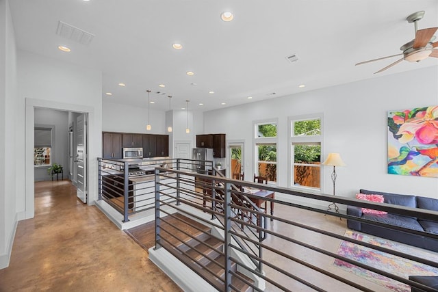1402 E 11th St, Austin, TX 78702 - hallway featuring an upstairs landing, concrete floors, recessed lighting, and baseboards