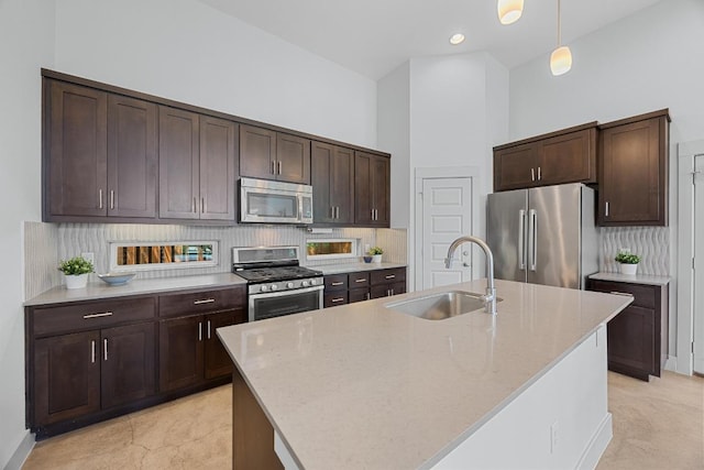 1402 E 11th St, Austin, TX 78702 - kitchen with appliances with stainless steel finishes, a sink, dark brown cabinetry, and hanging light fixtures