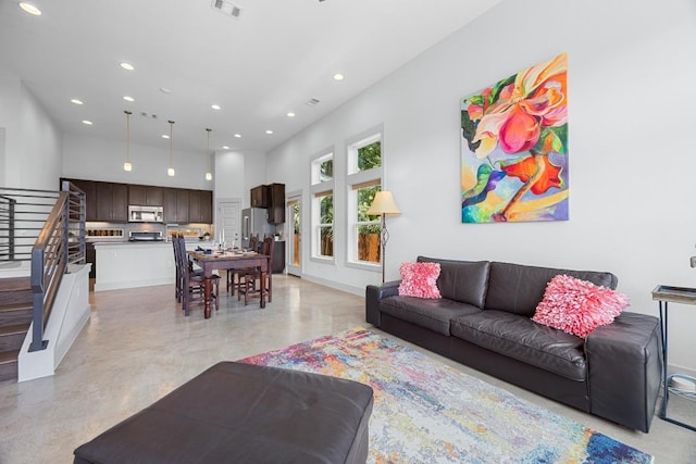1402 E 11th St, Austin, TX 78702 - living room featuring recessed lighting, stairs, and a towering ceiling