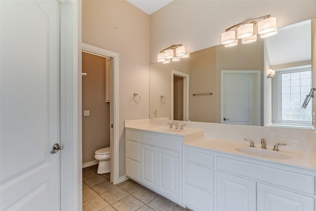 full bathroom featuring tile patterned flooring, double vanity, and toilet