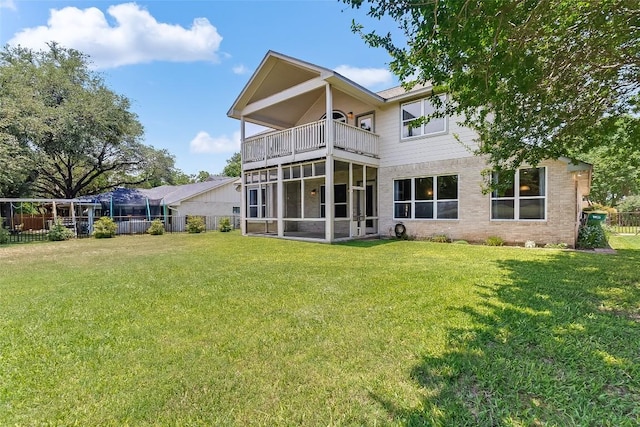 back of house with a balcony and a sunroom