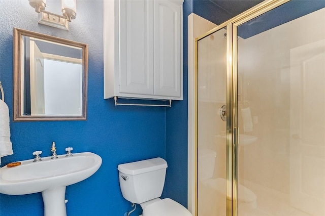 bathroom featuring a shower stall and toilet