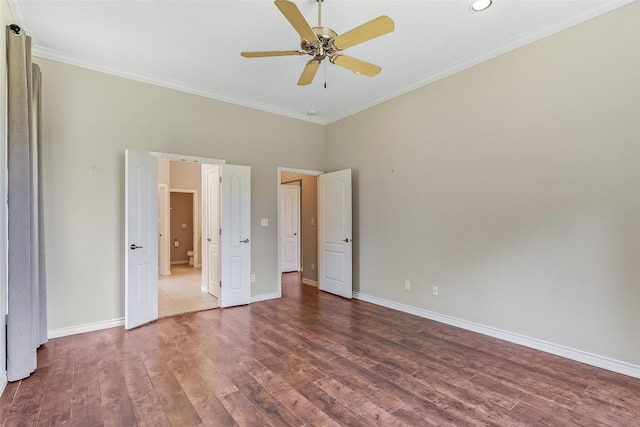 unfurnished bedroom with ornamental molding, wood finished floors, baseboards, and ceiling fan