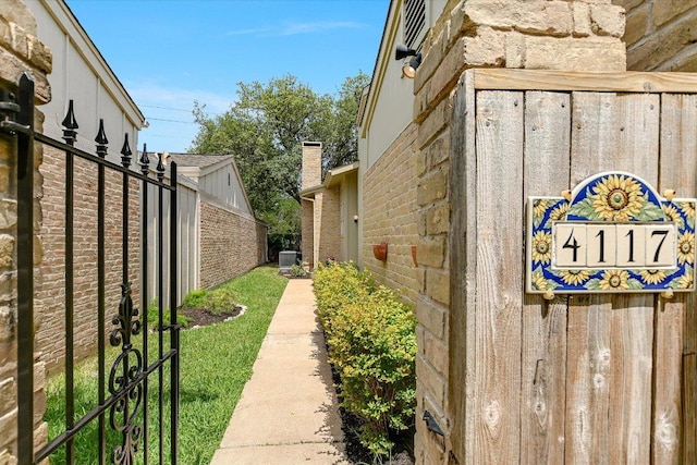4117 Ridgeline Dr, Austin, TX 78731 - view of side of property with central AC, brick siding, and a chimney