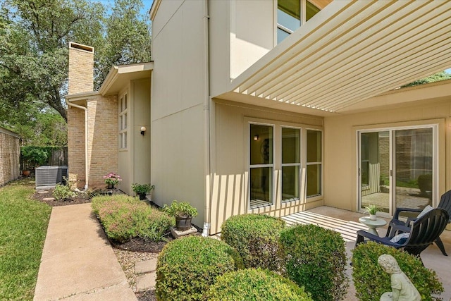 4117 Ridgeline Dr, Austin, TX 78731 - view of home's exterior with a chimney and central AC unit