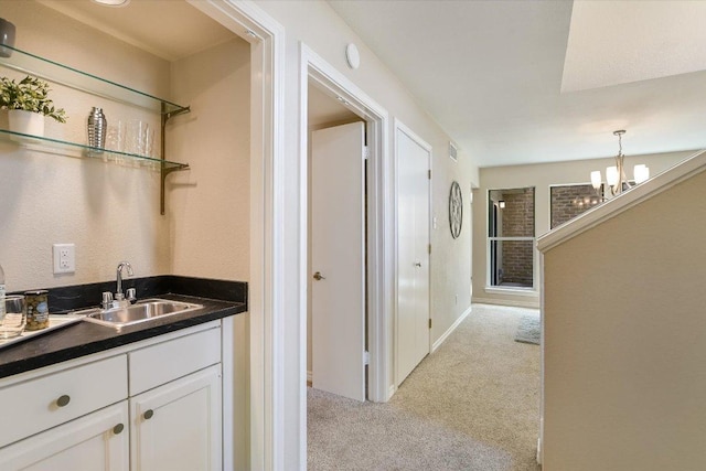 4117 Ridgeline Dr, Austin, TX 78731 - bar area with a sink, light colored carpet, a chandelier, and hanging light fixtures