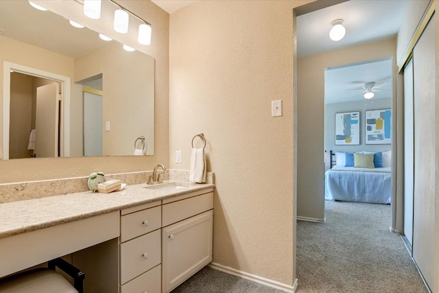4117 Ridgeline Dr, Austin, TX 78731 - bathroom with vanity, a textured wall, baseboards, ceiling fan, and connected bathroom