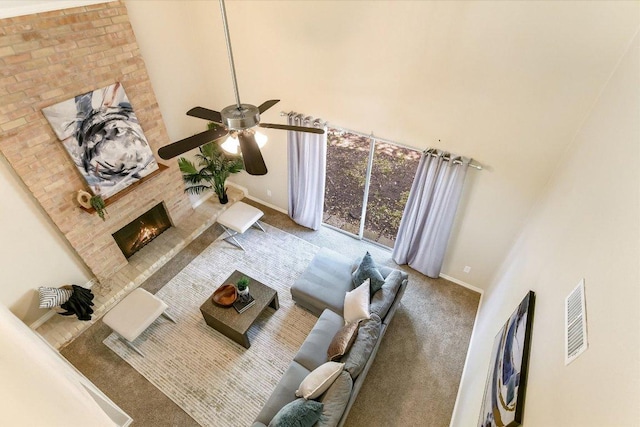 4117 Ridgeline Dr, Austin, TX 78731 - carpeted living area featuring a fireplace, baseboards, a high ceiling, and ceiling fan