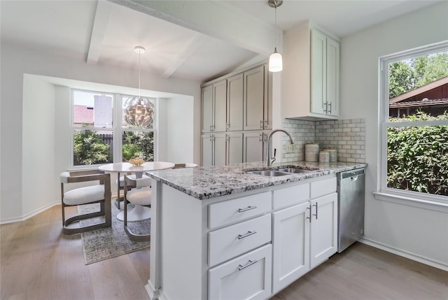2603 Carlow Dr, Austin, TX 78745 - kitchen featuring stainless steel dishwasher, a sink, light wood-type flooring, tasteful backsplash, and beamed ceiling
