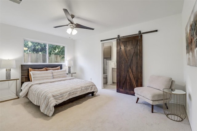 2603 Carlow Dr, Austin, TX 78745 - bedroom featuring light colored carpet, a barn door, ensuite bathroom, and ceiling fan