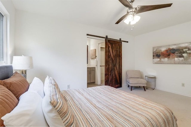 2603 Carlow Dr, Austin, TX 78745 - bedroom with a barn door, carpet, ensuite bath, a ceiling fan, and baseboards