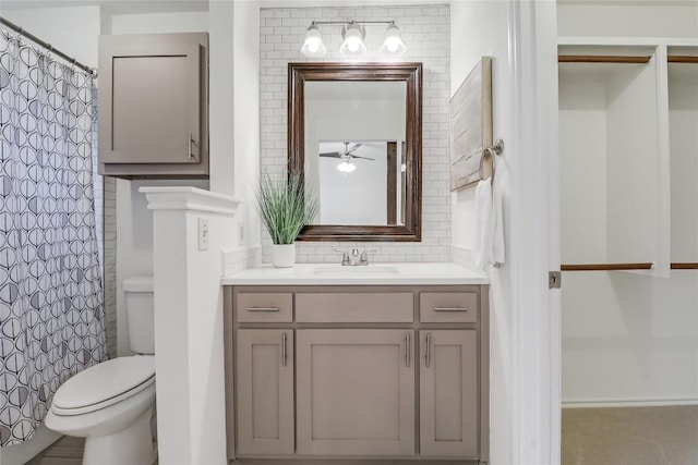 2603 Carlow Dr, Austin, TX 78745 - full bathroom with toilet, vanity, a ceiling fan, a shower with curtain, and tasteful backsplash