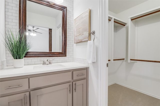 2603 Carlow Dr, Austin, TX 78745 - bathroom featuring vanity, a ceiling fan, and tasteful backsplash