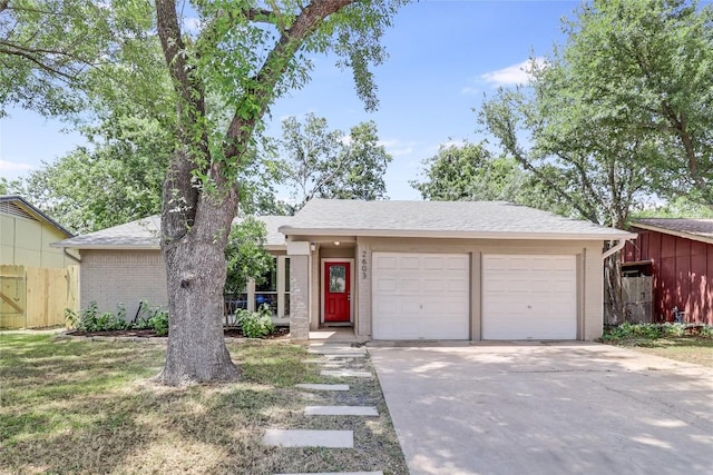 2603 Carlow Dr, Austin, TX 78745 - view of front of house with driveway, an attached garage, and brick siding