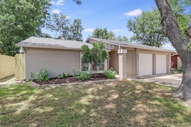 2603 Carlow Dr, Austin, TX 78745 - mid-century home featuring an attached garage, brick siding, concrete driveway, and roof with shingles