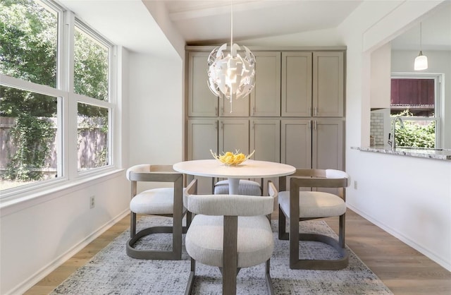 2603 Carlow Dr, Austin, TX 78745 - dining space featuring plenty of natural light, light wood-type flooring, a chandelier, and baseboards