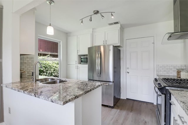 2603 Carlow Dr, Austin, TX 78745 - kitchen featuring stainless steel appliances, exhaust hood, white cabinets, light wood-style flooring, and light stone counters
